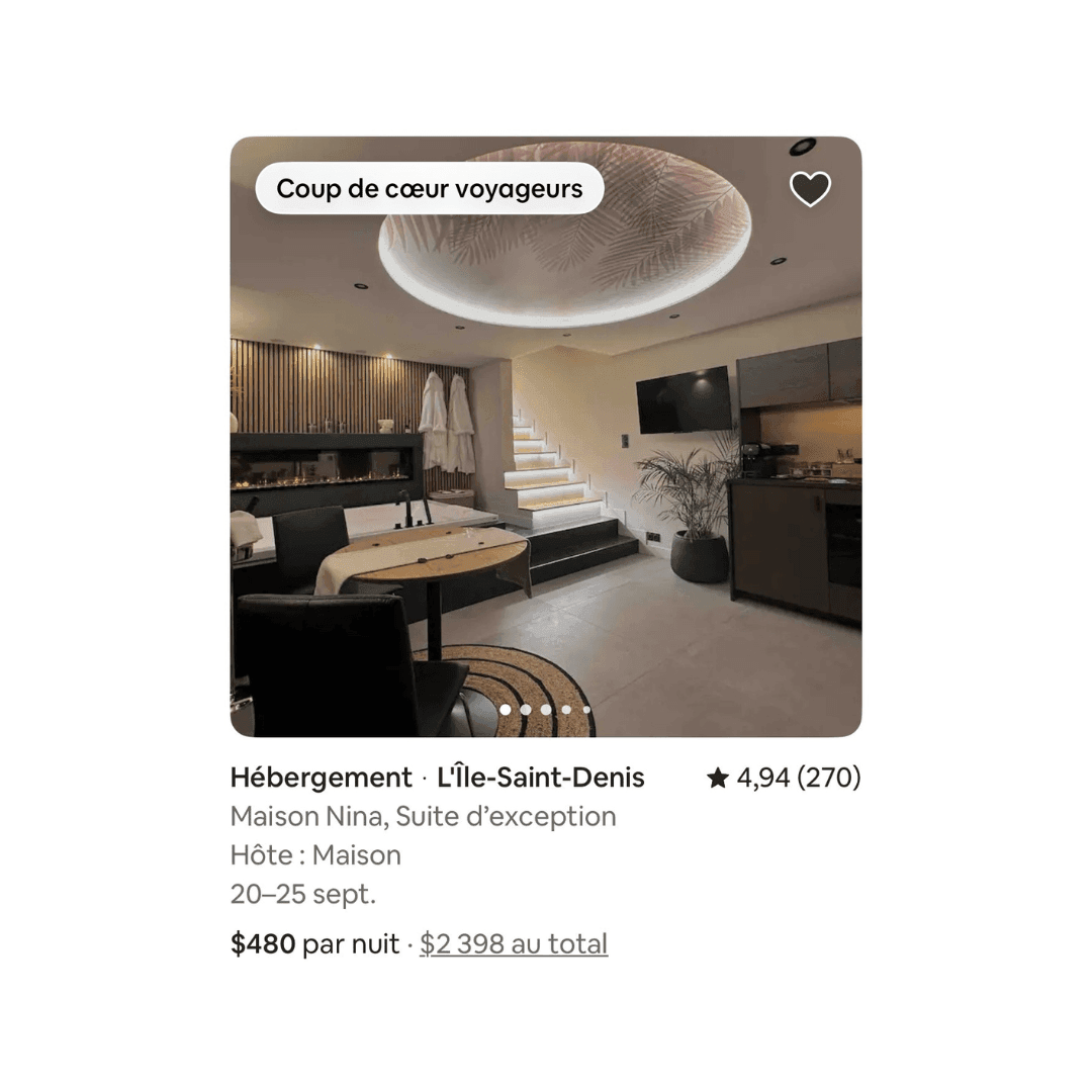 Luxurious modern suite featuring a decorative ceiling, cozy seating area, kitchenette, and illuminated staircase.
